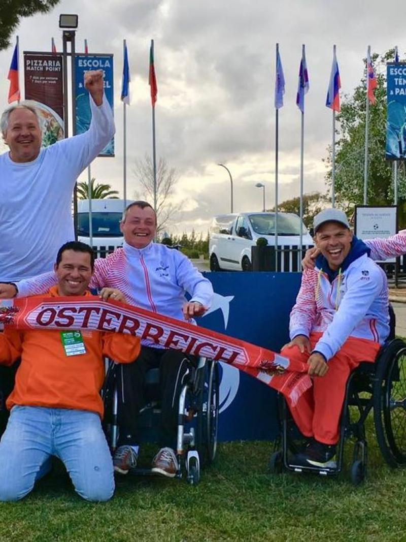 male wheelchair tennis players from Austria holding up Austrian scarves and flags