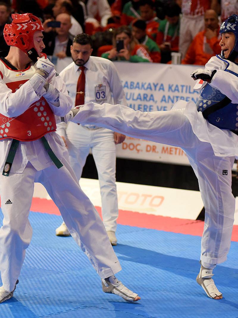 male Para taekwondo fighter Juan Diego Garcia Lopez kicks another fighter in the chest