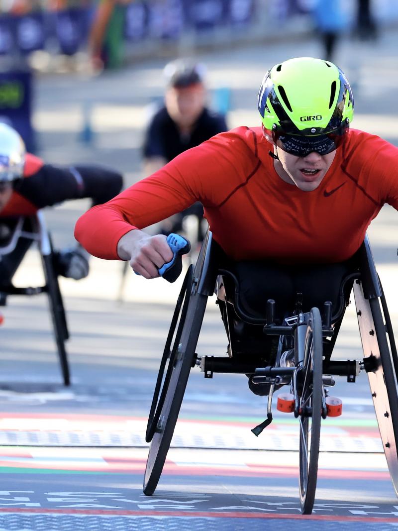 marathon racer Daniel Romanchuk crosses the finish line to win