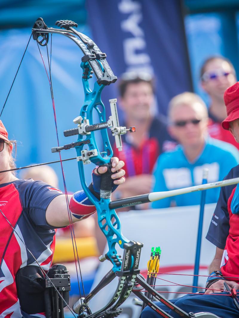 female Para archer Jessica Stretton prepares to shoot an arrow
