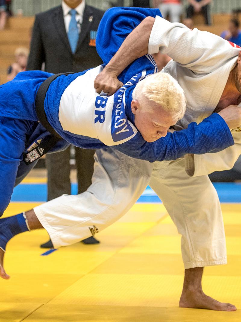male judoka Ramil Gasimov wrestles another judoka to the ground