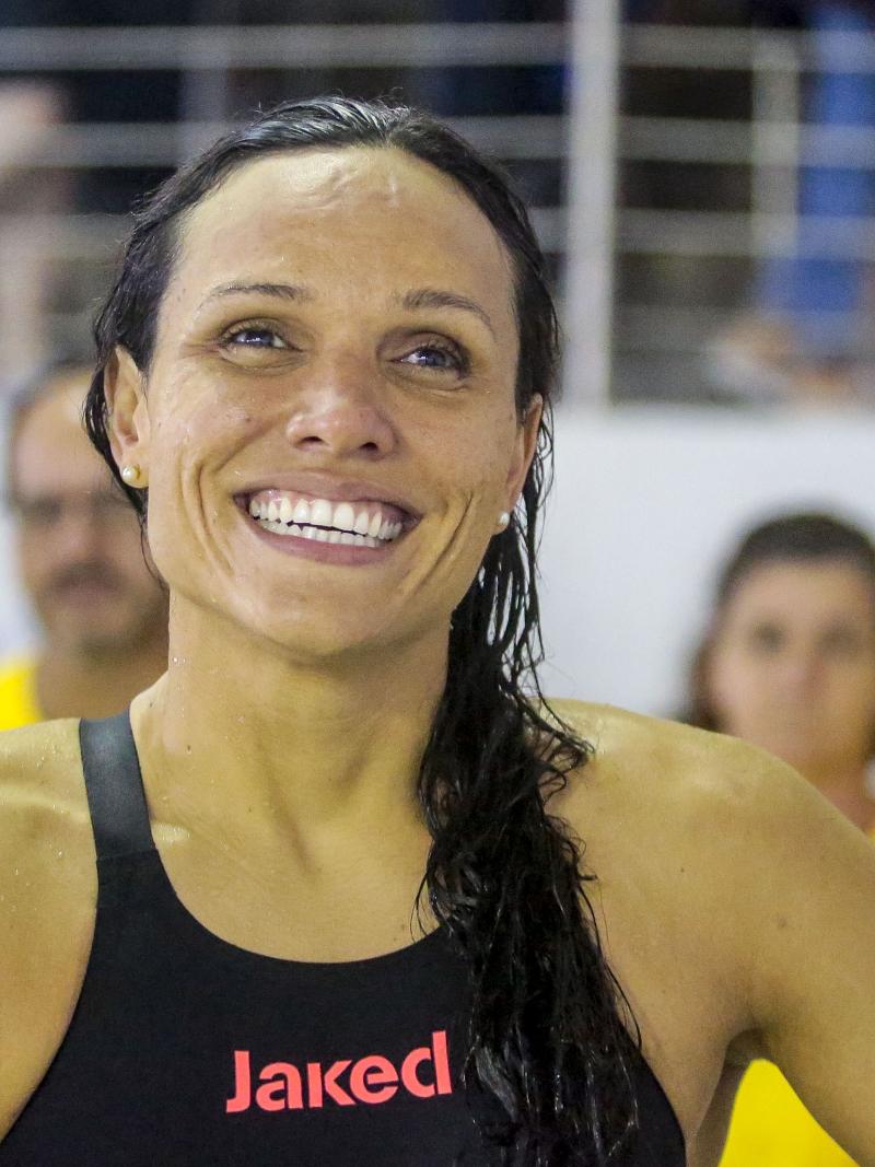Maria Carolina Gomes smiling while wearing her swimsuit