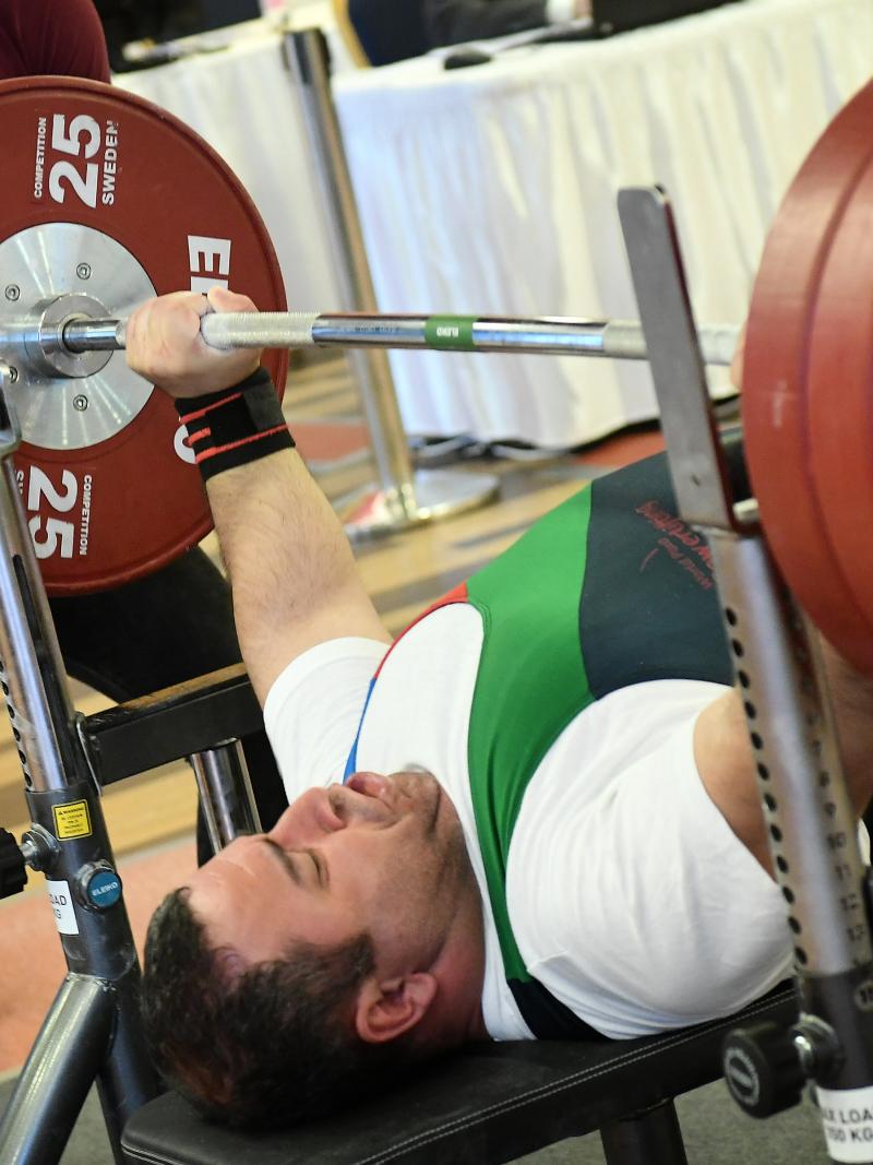 male Para powerlifter Elshan Huseynov prepares to lift the bar