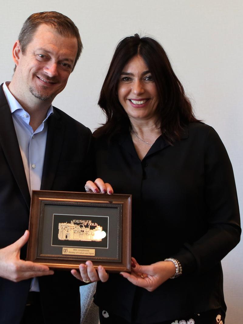 A man and a woman holding a plate