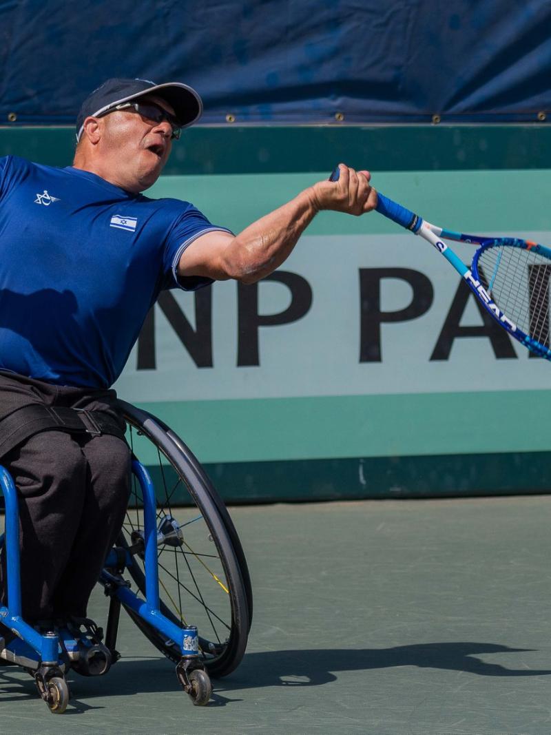 Israeli left-handed wheelchair tennis player Shraga Weinberg hits the ball during a game contested on a hard court