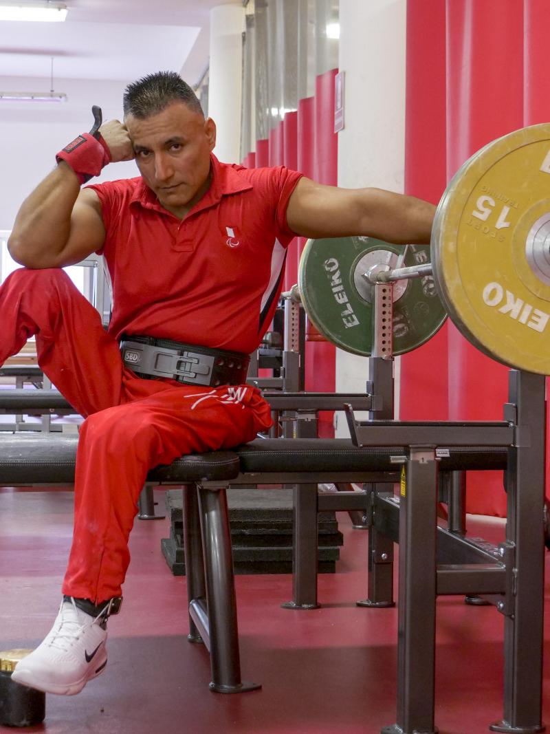 Peruvian powerlifter Niel Garcia Trelles poses on the benche staring at the camera