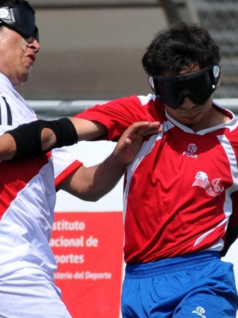 Peruvian and Chilean blind football players fight for the ball