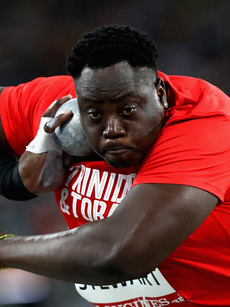 Akeem Stewart about to throw the shot while wearing a Trinidad & Tobago shirt
