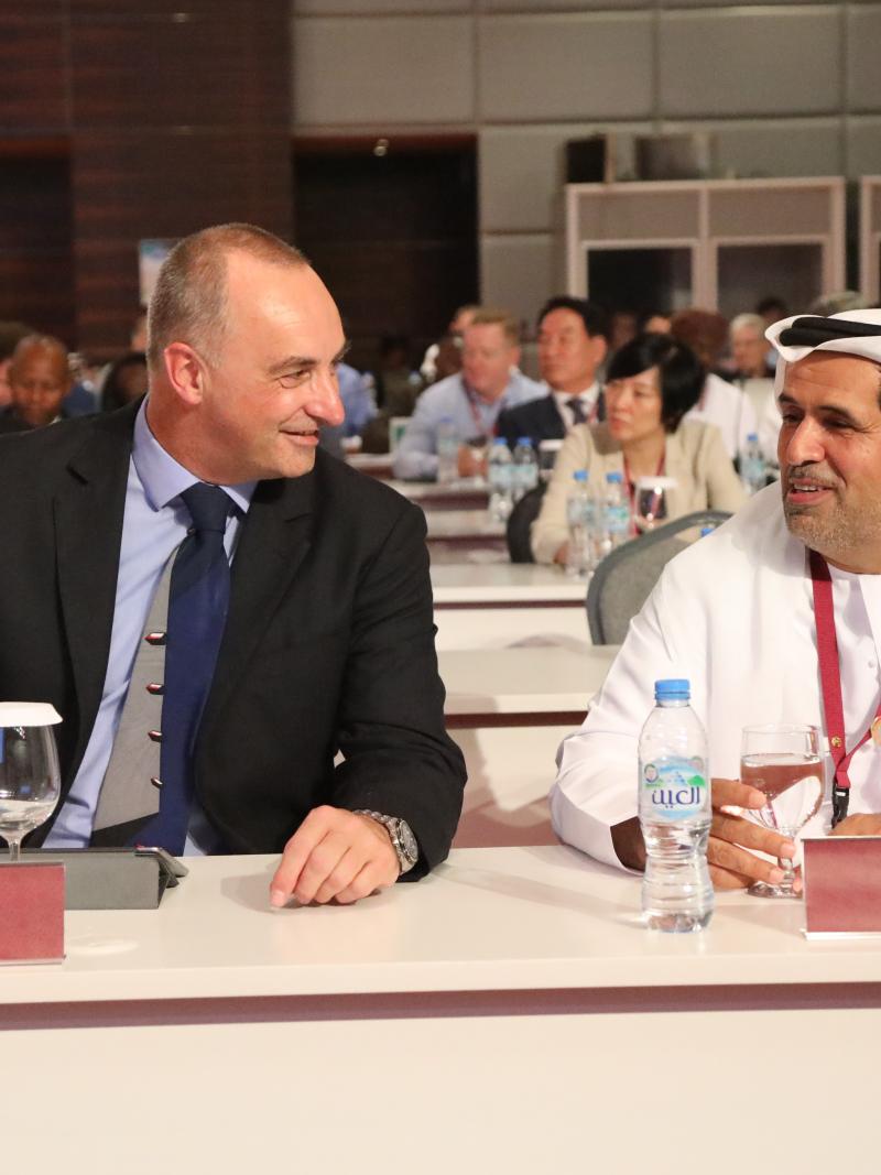 Two men talking to each other at a conference