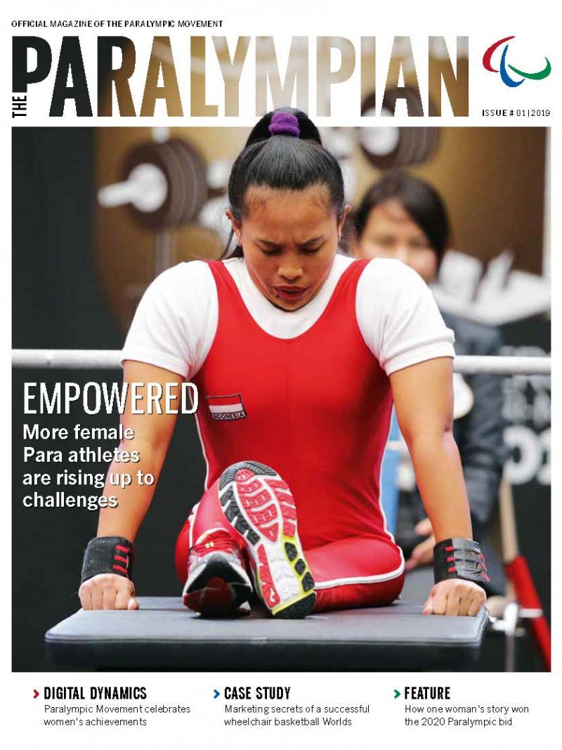 Magazine cover photo of Asian powerlifting bowing her head
