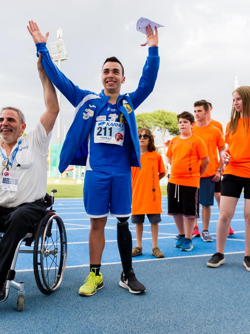 male Para athlete Lorenzo Marcantognini celebrates waving on the podium