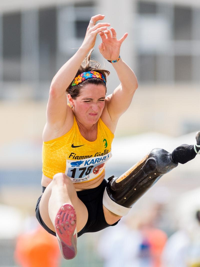 A woman with a prosthetic leg jumping