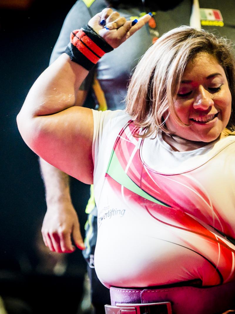 Amalia Perez smiles and points to the sky