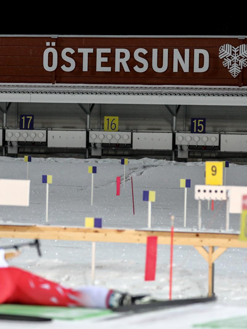 A female Para biathlete laying on the ground to shoot on the target