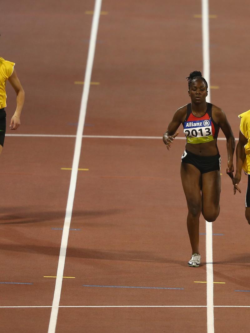 Two female vision impaired sprinters racing with their guides