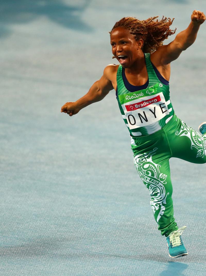 A short-statured woman celebrating