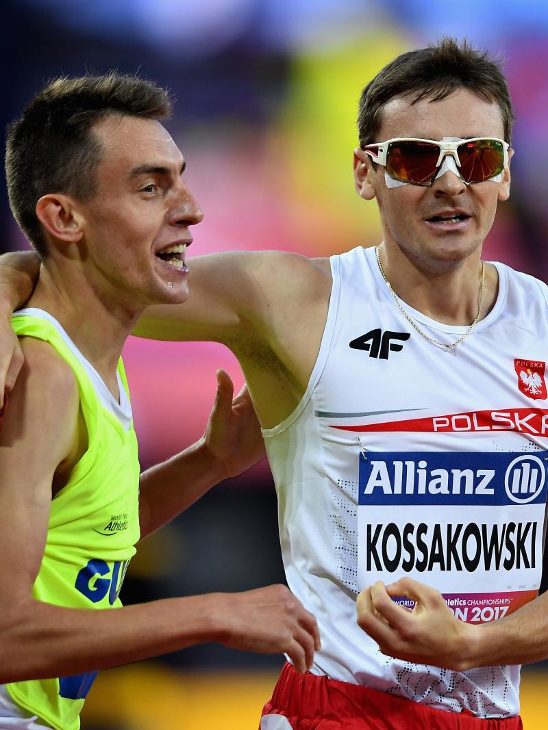 A male athlete celebrating with his guide