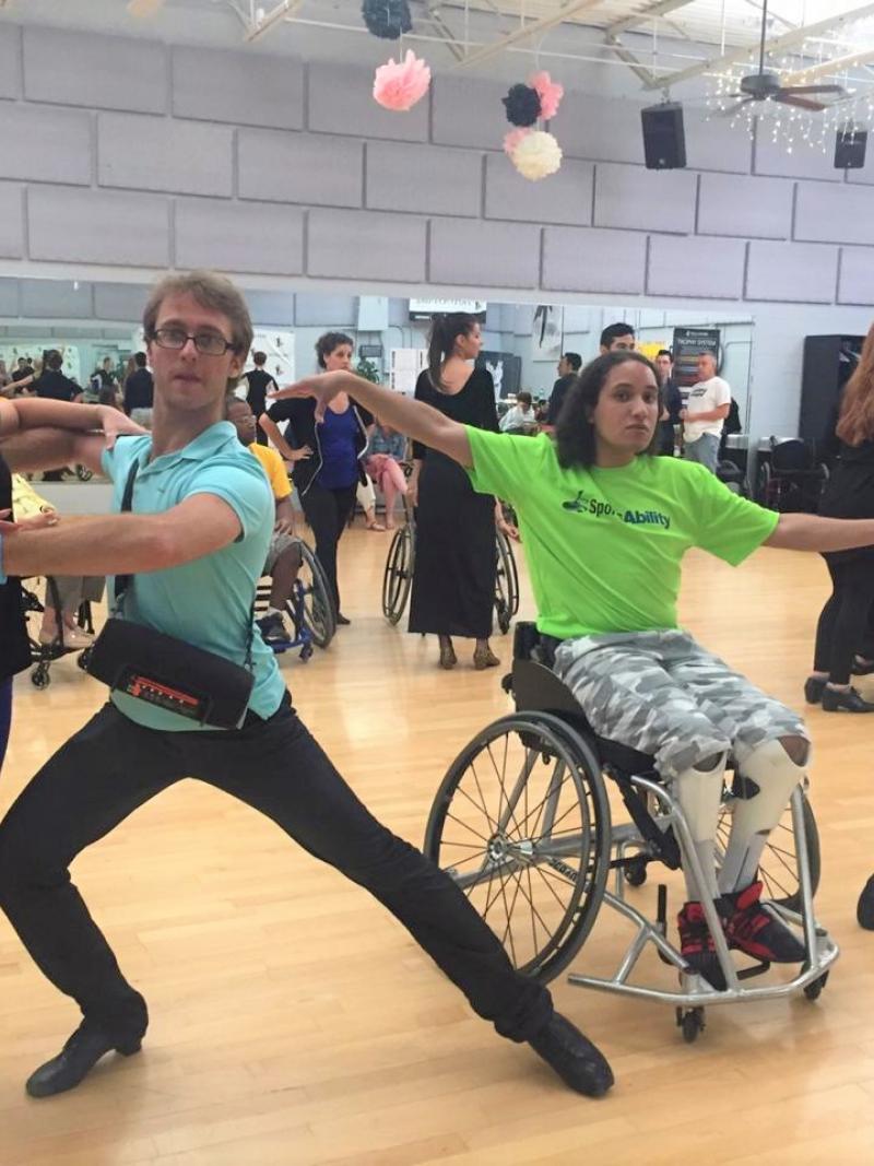 Two pairs of Para dance couples pose in a dance studio
