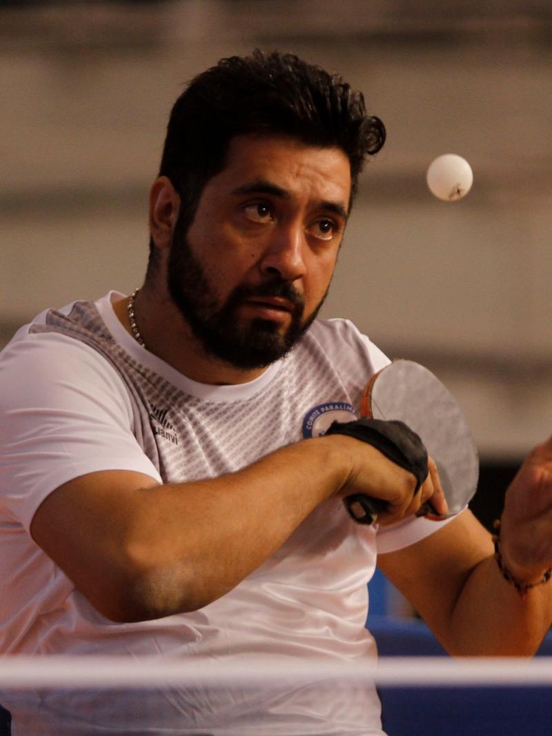 Chilean table tennis player Luis Flores serving