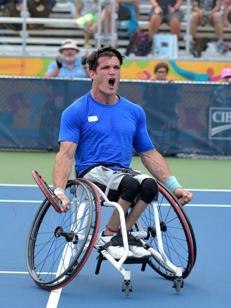 Argentinian wheelchair tennis player Gustavo Fernandez screams with joy on the court after winning gold at Toronto 2015