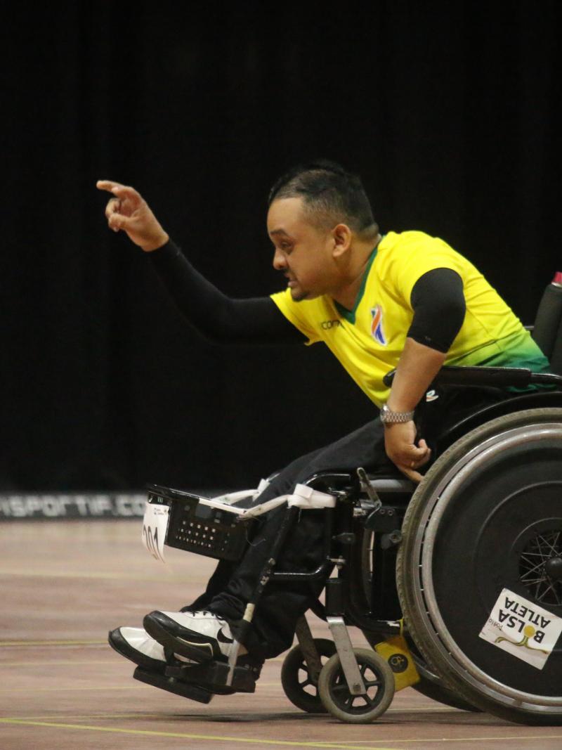 Brazilian boccia player in powerchair throws a ball