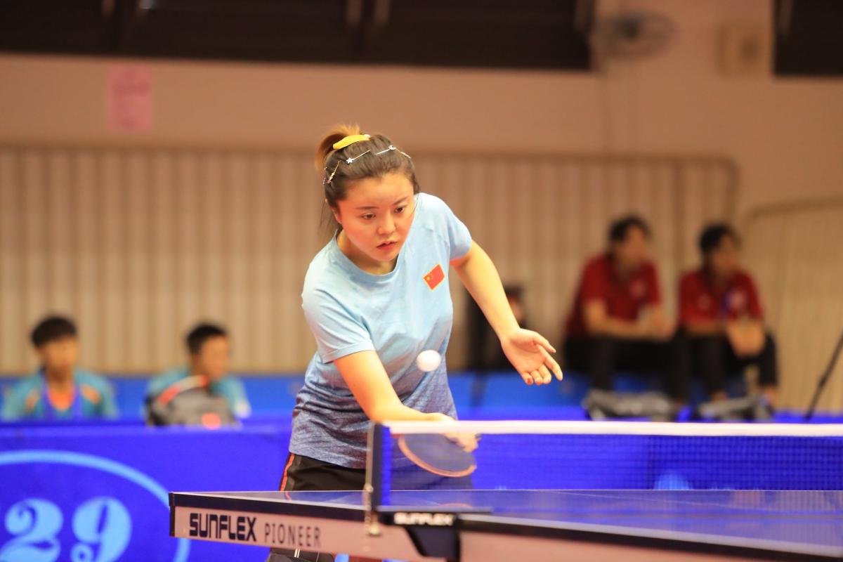 Chinese female table tennis player hits a return ball