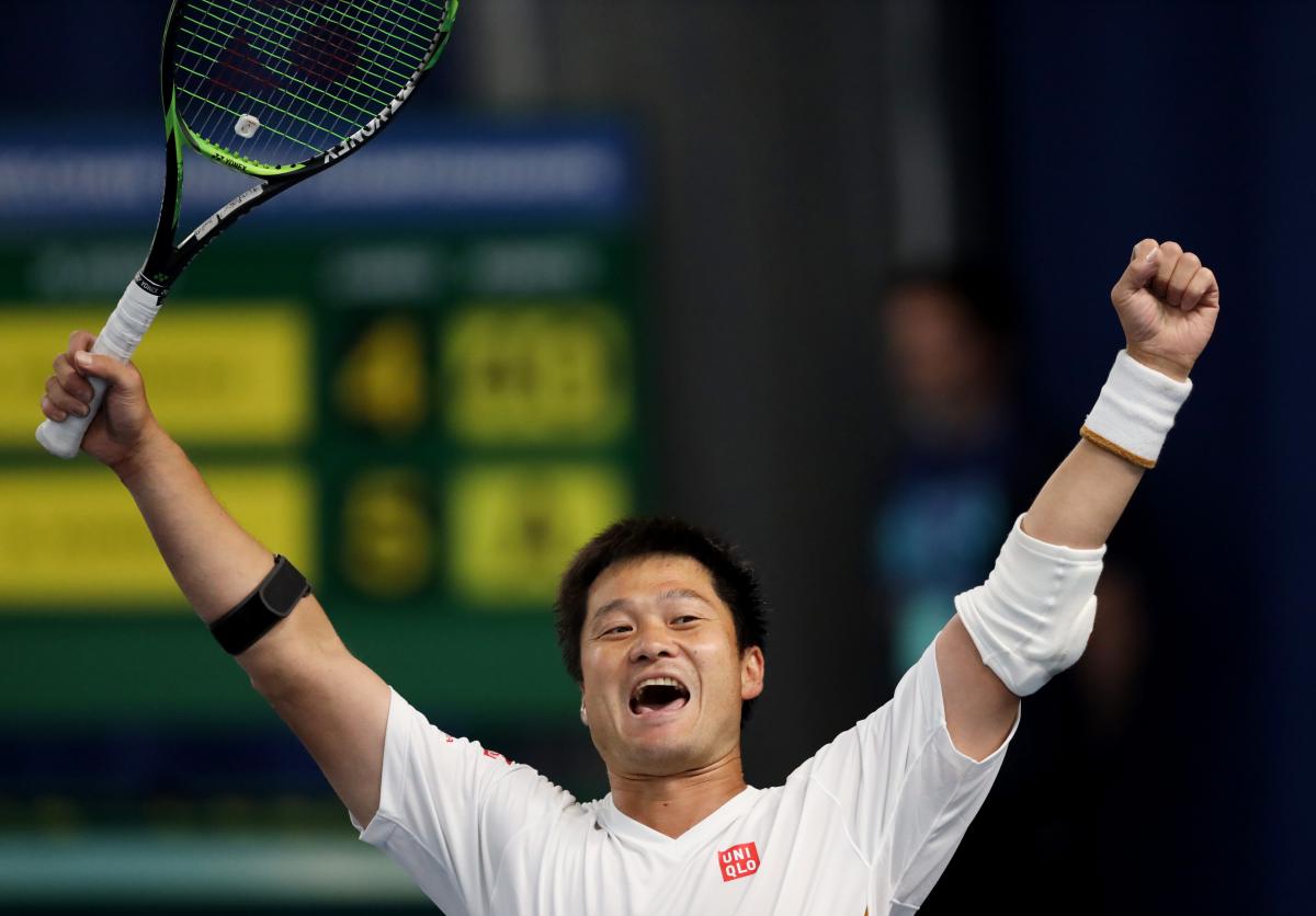 Japanese wheelchair tennis player Shingo Kunieda lifts his arms after winning the final