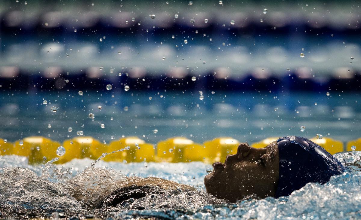 A woman swimming backstroke