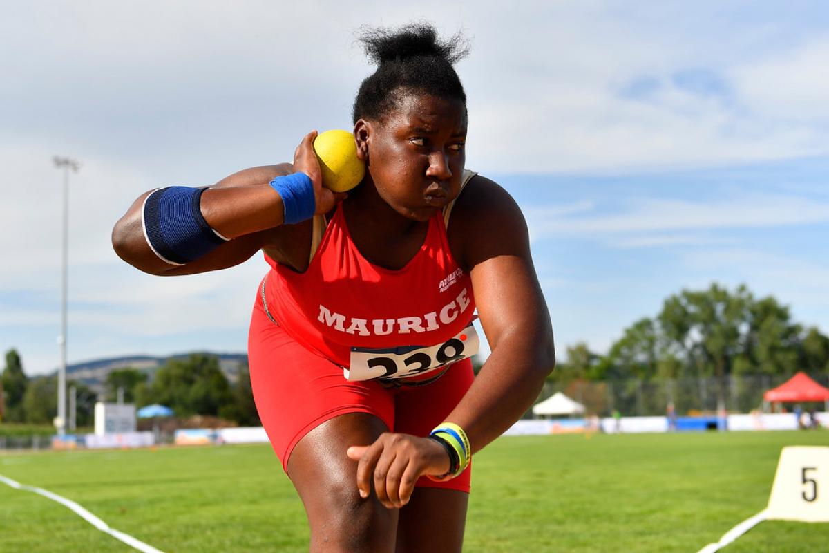 Teenage Mauritian female athlete prepares to release shot put