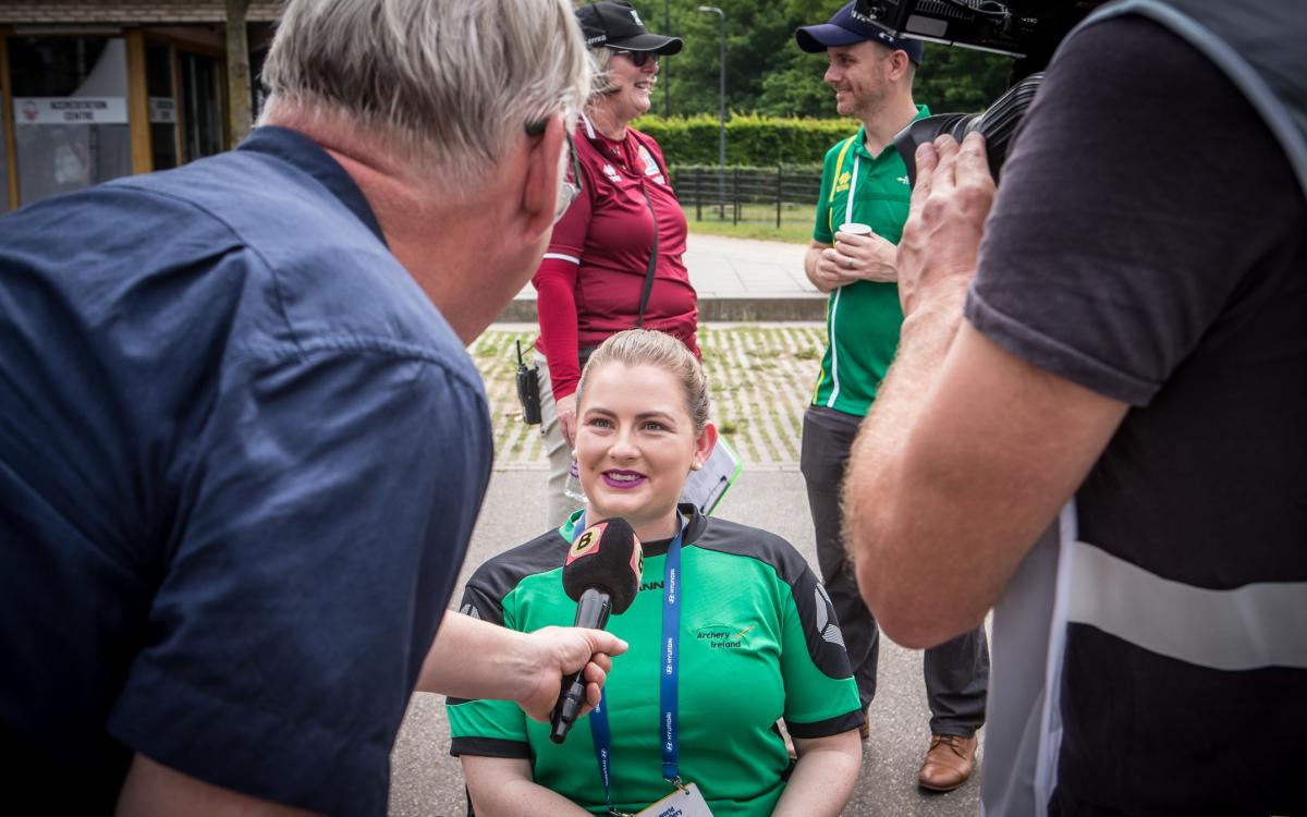 Woman in wheelchair being interviewed by media