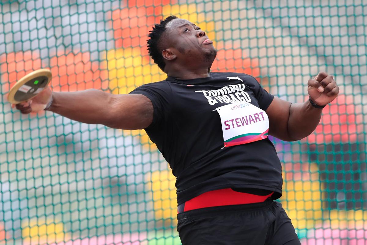 a male Para athlete throws a discus