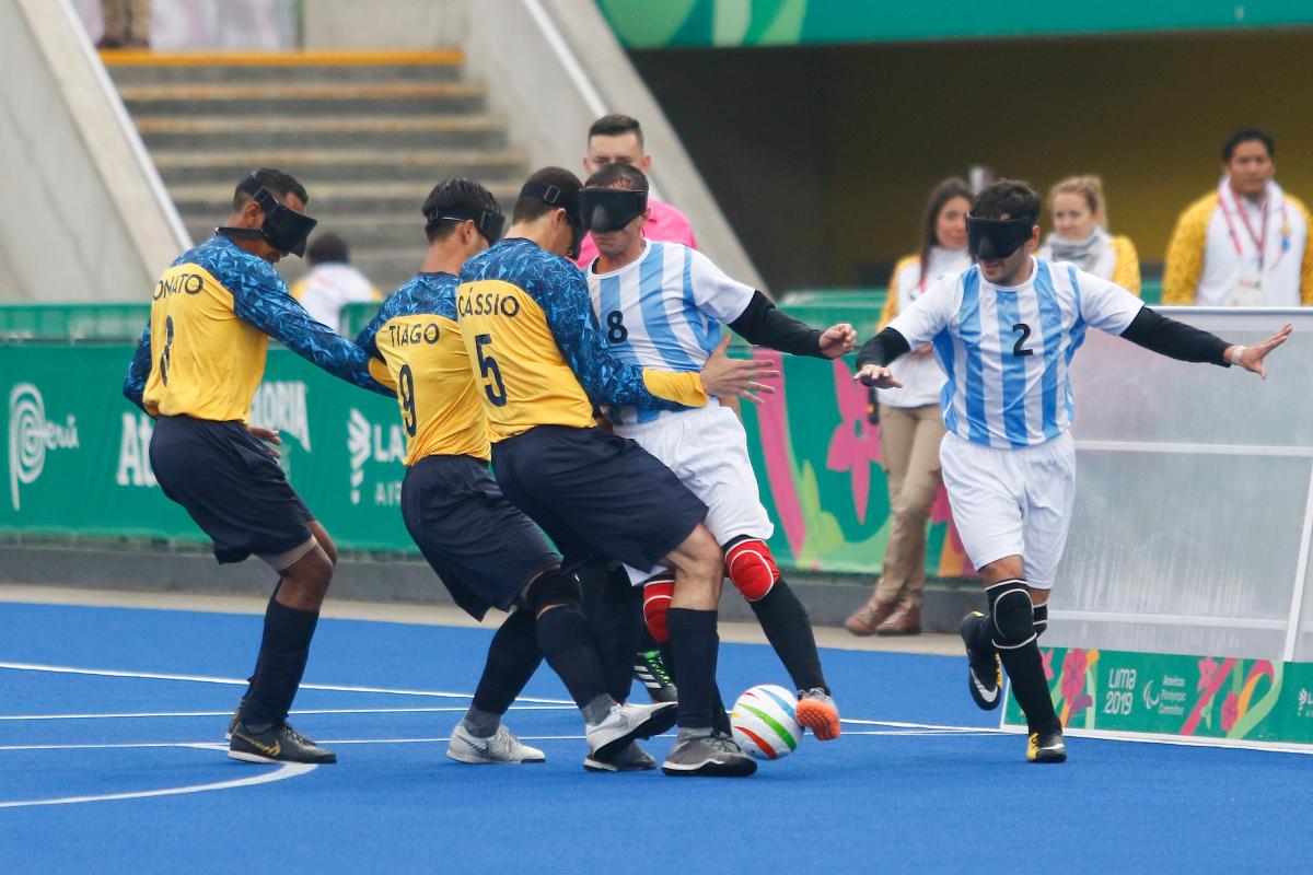 male blind footballers tackling for the ball