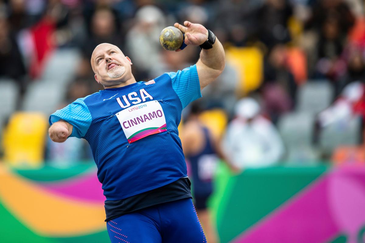 a male Para athlete throws a shot put