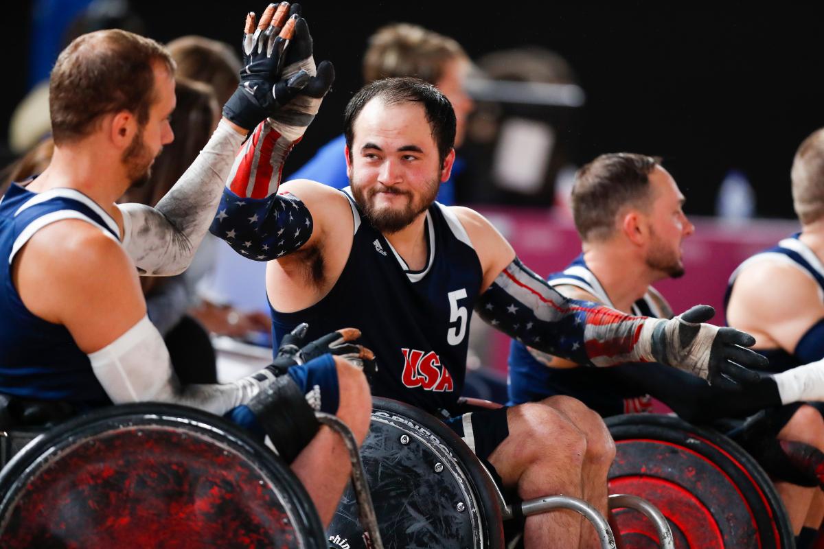 male wheelchair rugby players high-five