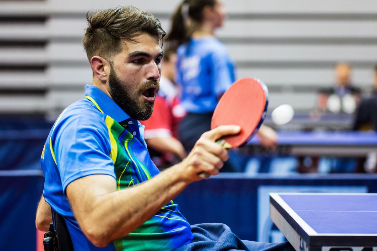 Man in wheelchair returns a shot in table tennis