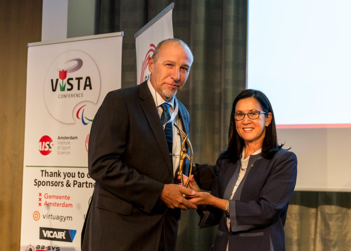 Woman presents man with award