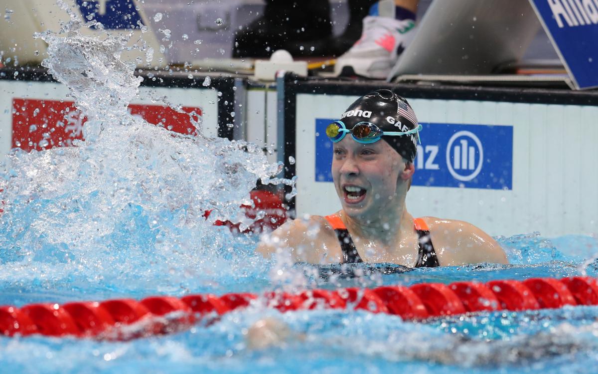 US female swimmer splashes water to celebrate