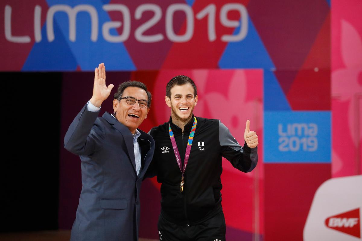 two men giving a thumbs up on the podium