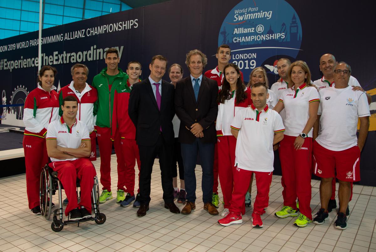 A male wheelchair user and 15 standing men and women