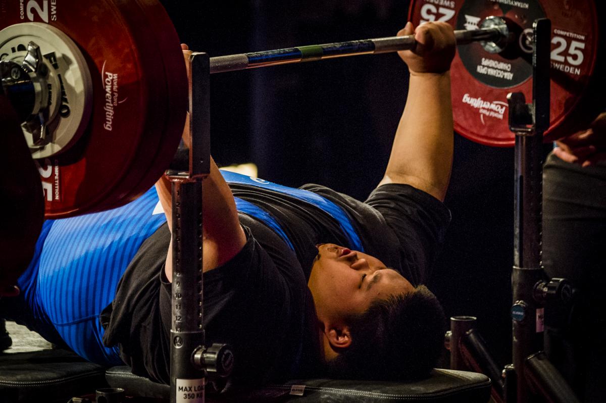 A male powerlifter lifting the bar