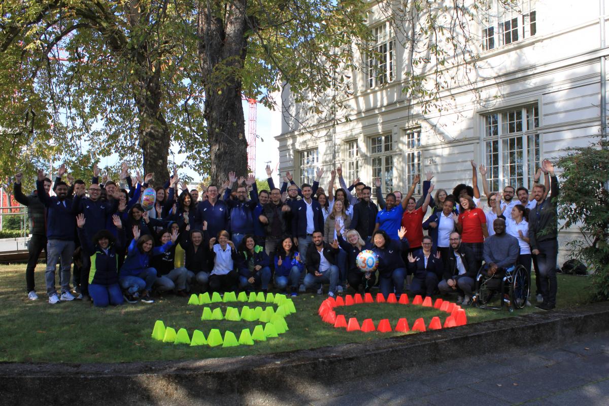 IPC staff in Bonn gathers infront of headquarter building with number 30 marked on lawn