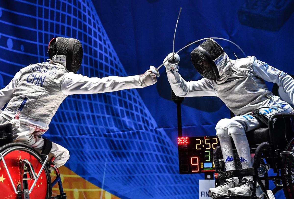 Two wheelchair fencers battling