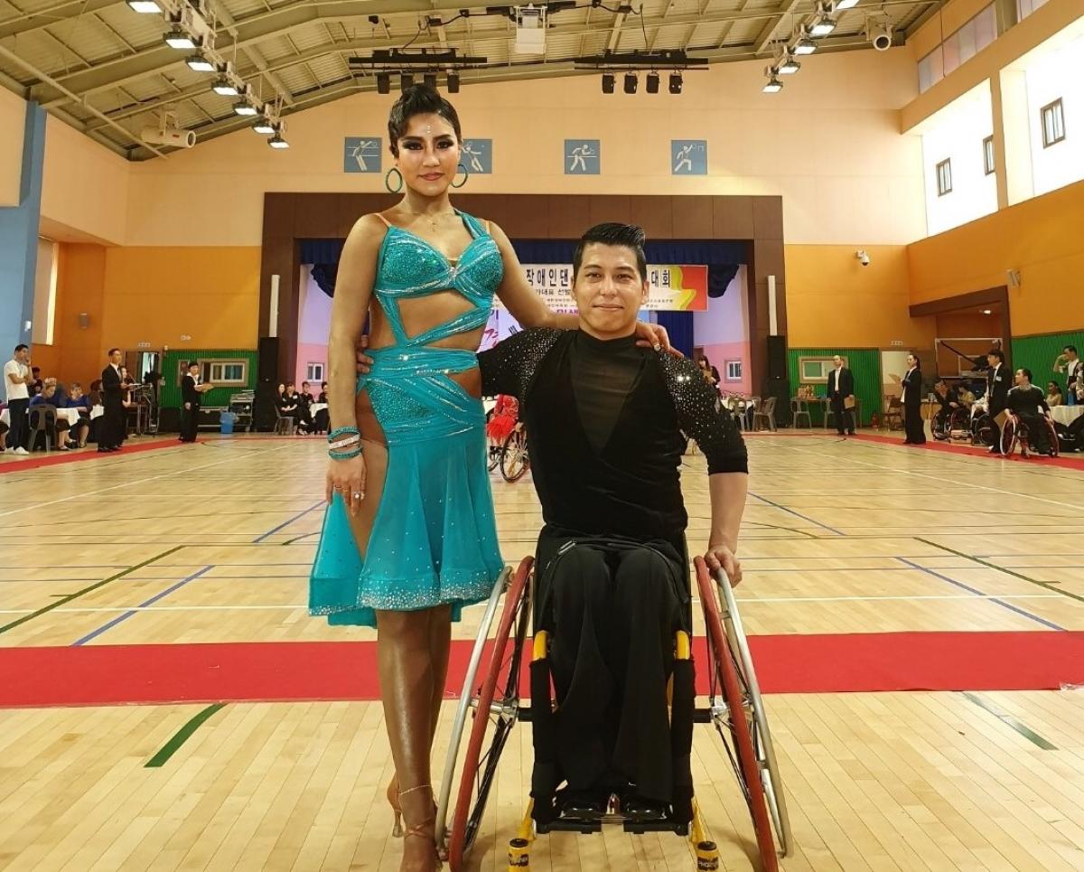 Male Korean wheelchair dancer poses with female standing partner