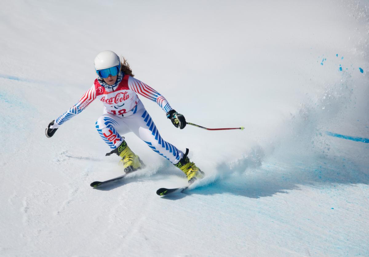 A female Para alpine skier competing on the snow