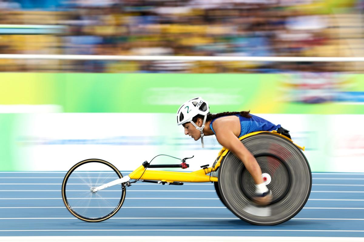 A female wheelchair racer on a blue track