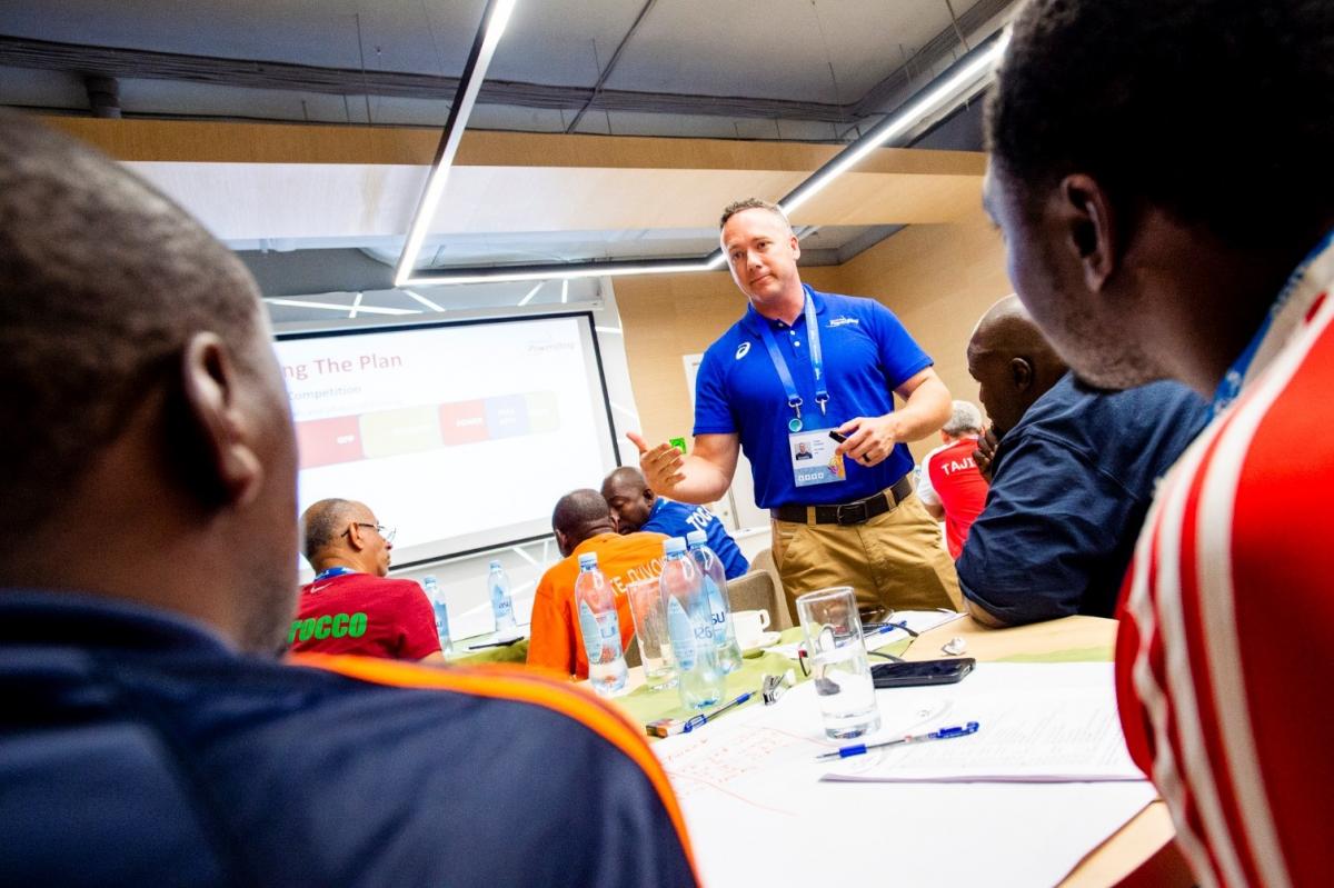 Powerlifting mentor speaks during an educational course