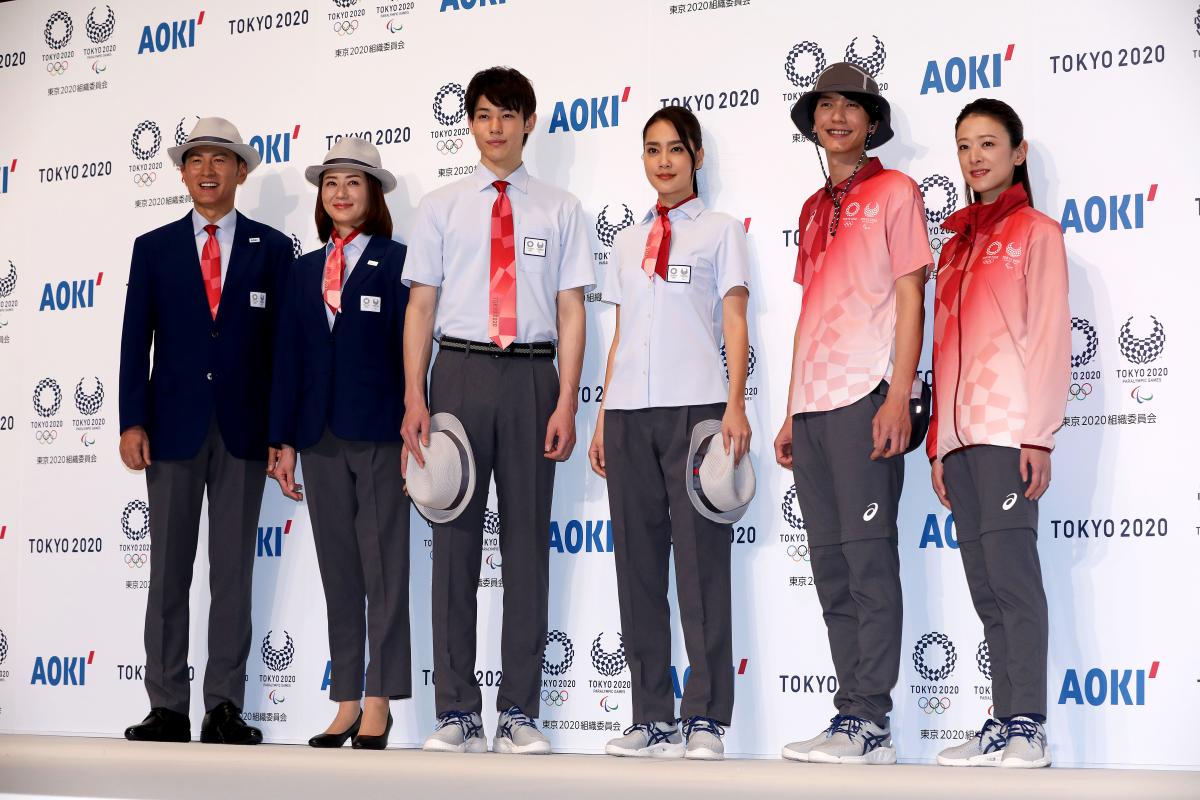 Models posing with Tokyo 2020 technical officials uniforms