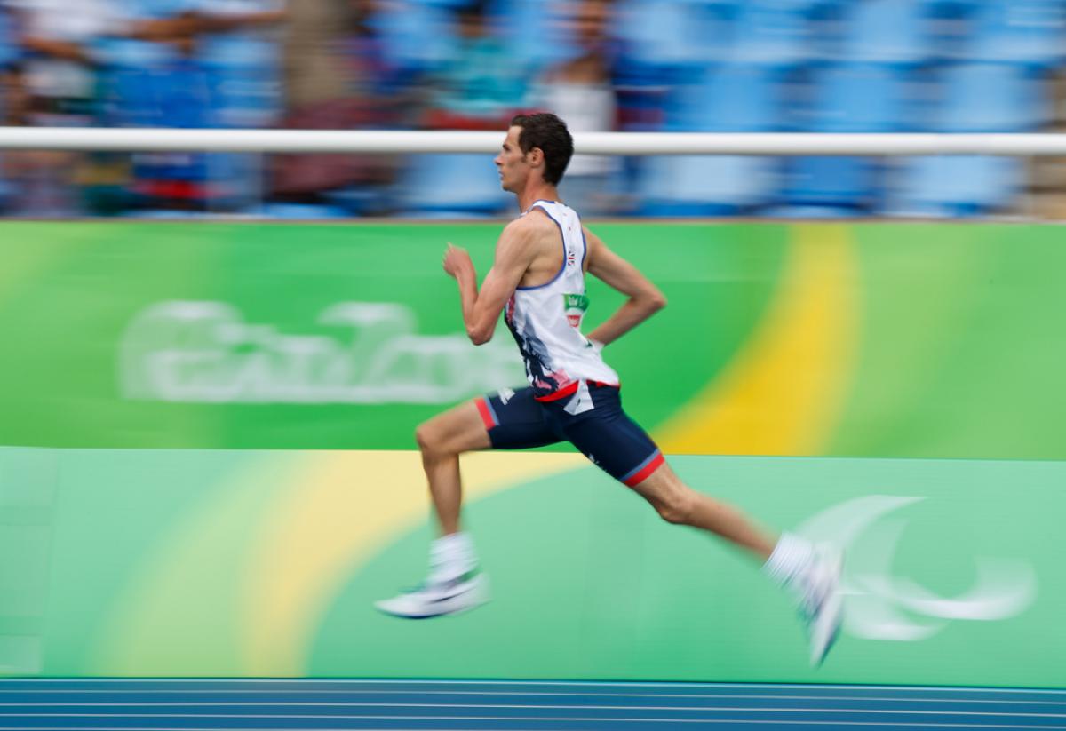 A man running on an athletics track