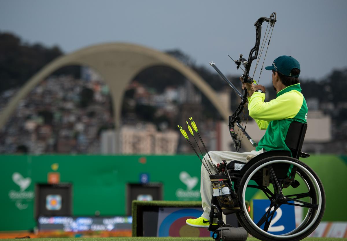Brazilian male archer in his wheelchair aiming at the target