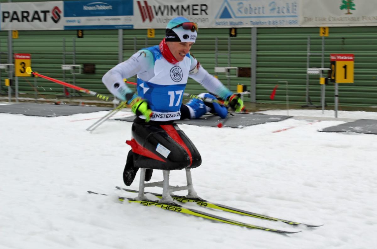 A male sit-skier competing on the snow